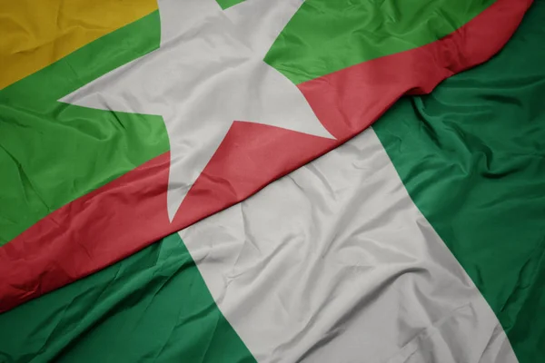 ナイジェリアのカラフルな旗とミャンマーの国旗を振って. — ストック写真