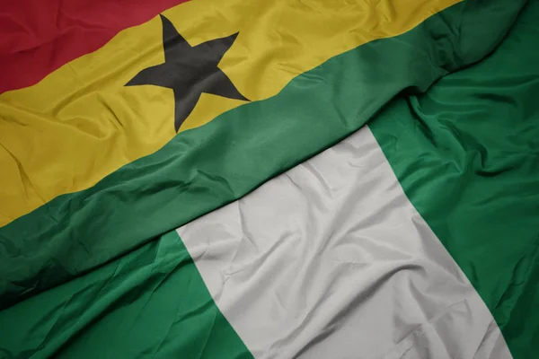 Waving colorful flag of nigeria and national flag of ghana. — Stock Photo, Image