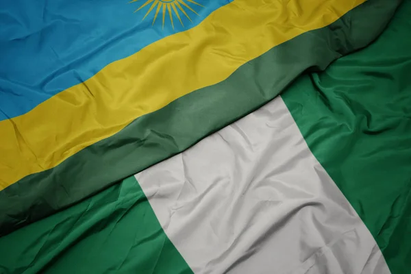 Zwaaiende vlag van Nigeria en nationale vlag van Nigeria. — Stockfoto