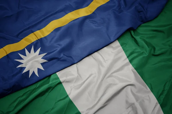Acenando bandeira colorida de nigeria e bandeira nacional de Nauru  . — Fotografia de Stock