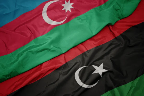Ondeando colorida bandera de libya y bandera nacional de azerbaijan . — Foto de Stock