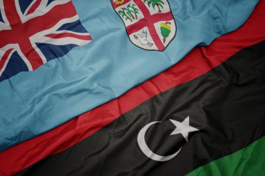 Libya 'nın renkli bayrağı ve Fiji' nin ulusal bayrağı sallanıyor. .