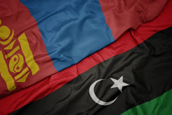Ondeando colorida bandera de libya y bandera nacional de mongolia . — Foto de Stock