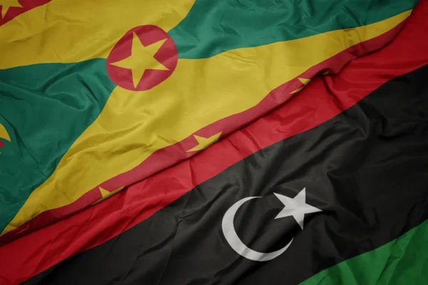 Libya 'nın renkli bayrağı ve Grenada' nın ulusal bayrağı sallanıyor.. — Stok fotoğraf