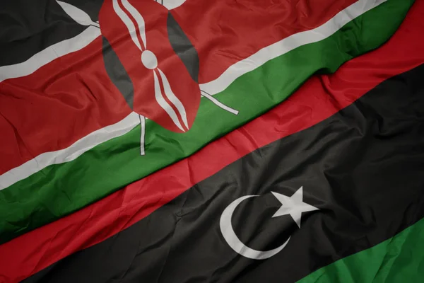 リビアのカラフルな旗とケニアの国旗を振って. — ストック写真