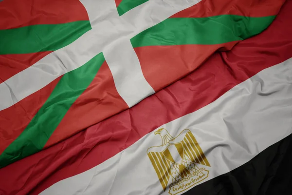 Waving colorful flag of egypt and national flag of basque country. — Stock Photo, Image