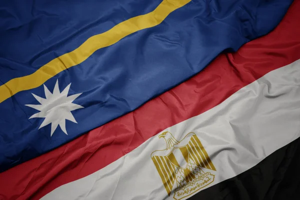 waving colorful flag of egypt and national flag of Nauru .