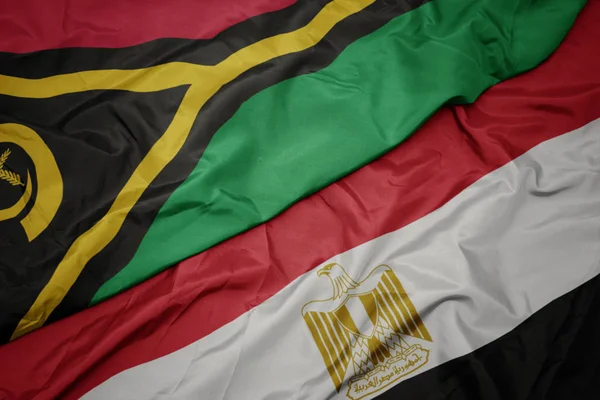 waving colorful flag of egypt and national flag of Vanuatu .