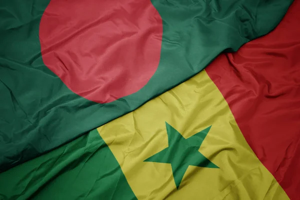 Schwenken bunte senegalesische Flagge und Nationalflagge von Bangladesh. — Stockfoto