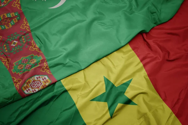 Waving colorful flag of senegal and national flag of turkmenistan. — Stock Photo, Image
