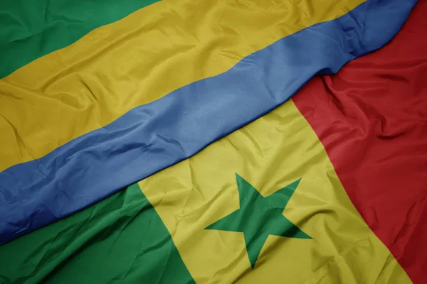 Waving colorful flag of senegal and national flag of gabon. — Stock Photo, Image