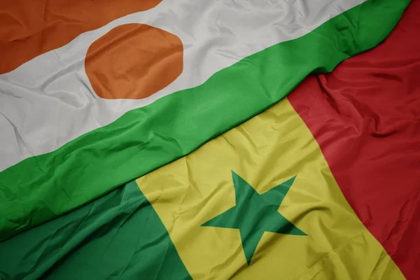 Waving colorful flag of senegal and national flag of niger. — Stock Photo, Image