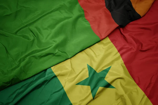 Waving colorful flag of senegal and national flag of zambia. — Stock Photo, Image