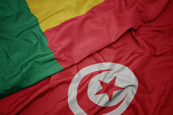 Waving colorful flag of tunisia and national flag of benin. — ストック写真