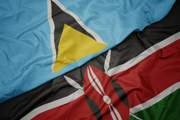 Agitant drapeau coloré du Kenya et drapeau national de Sainte-Lucie . — Photo