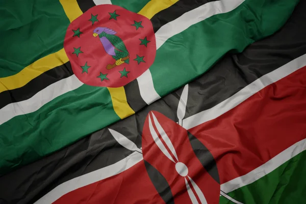 Agitant le drapeau coloré du Kenya et le drapeau national de la Dominique . — Photo