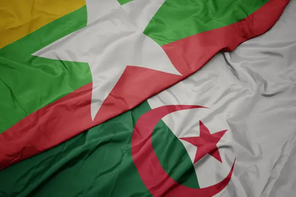 Schwenken bunte Flagge von Algerien und Nationalflagge von Myanmar. — Stockfoto