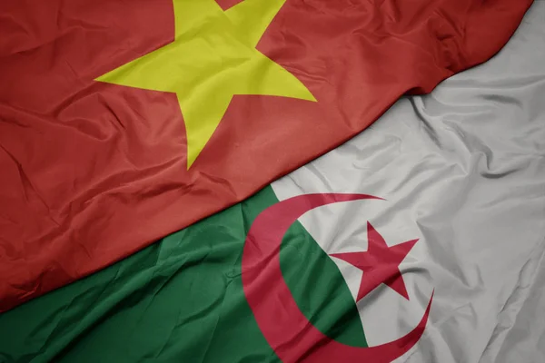 アルジェリアのカラフルな旗とベトナムの国旗を振って. — ストック写真