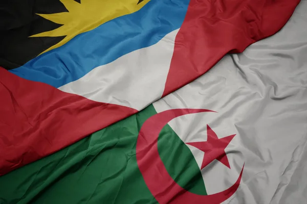 Schwenken bunte Flagge von Algerien und Nationalflagge von Antigua und Barbuda. — Stockfoto