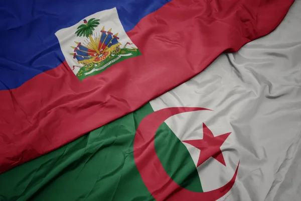 Schwenken bunte Flagge von Algerien und Nationalflagge von Haiti. — Stockfoto