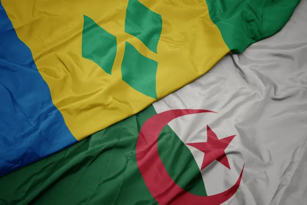 Schwenken bunte algerische Flagge und Nationalflagge von Saint Vincent und den Grenadinen. — Stockfoto