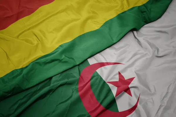Schwenken bunte Flagge von Algerien und Nationalflagge von Bolivien. — Stockfoto