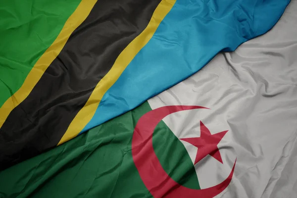 Schwenken bunte Flagge von Algerien und Nationalflagge von Tansania. — Stockfoto