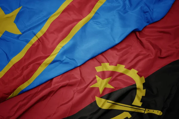 Waving colorful flag of angola and national flag of democratic republic of the congo. — Stock Photo, Image