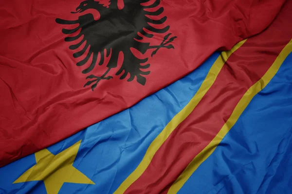 Waving colorful flag of democratic republic of the congo and national flag of albania. — Stock Photo, Image