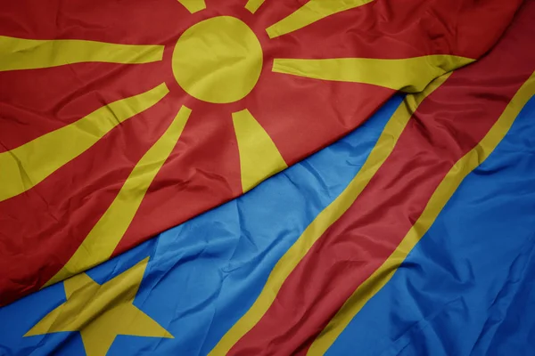 Viftande färgglada flagga demokratisk republik congo och nationell flagga macedonia. — Stockfoto