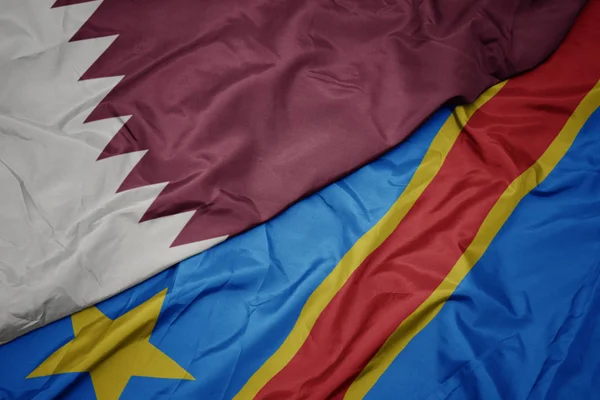 Waving colorful flag of democratic republic of the congo and national flag of qatar. — Stock Photo, Image