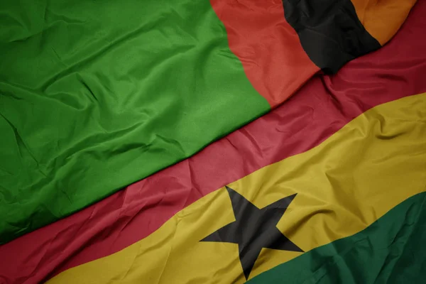 Waving colorful flag of ghana and national flag of zambia. — Stock Photo, Image