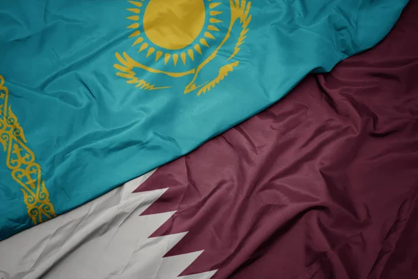 Waving colorful flag of qatar and national flag of kazakhstan. — Stock Photo, Image