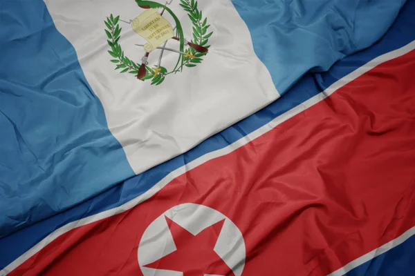 Kuzey Kore 'nin renkli bayrağı ve Guatemala' nın ulusal bayrağı sallanıyor.. — Stok fotoğraf