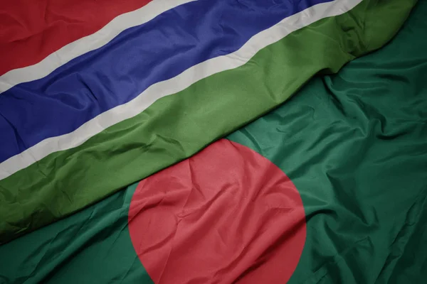 Sventolando bandiera colorata del bangladesh e bandiera nazionale della Gambia . — Foto Stock