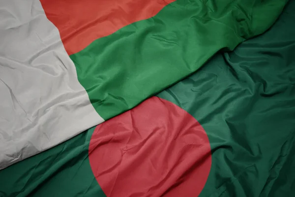 Waving colorful flag of bangladesh and national flag of madagascar. — Stock Photo, Image