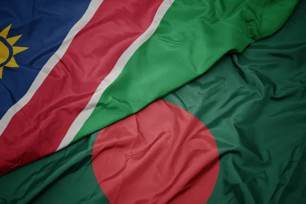 Machanie kolorową flagą Bangladeszu i flagą narodową Namibii. — Zdjęcie stockowe
