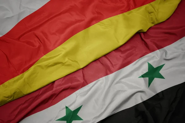 Wapperende vlag van syrië en nationale vlag van Zuid-ossetië. — Stockfoto