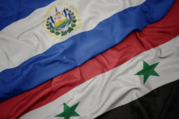 waving colorful flag of syria and national flag of el salvador.