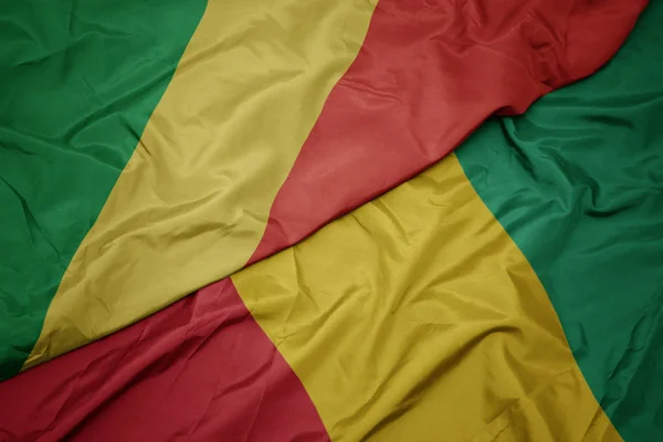 Ondeando colorida bandera de Guinea y bandera nacional de la república del congo . — Foto de Stock