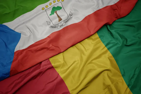 挥动着五彩缤纷的几内亚国旗和赤道几内亚国旗. — 图库照片