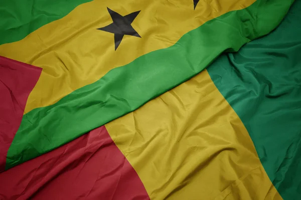 Waving colorful flag of guinea and national flag of sao tome and principe . — Stock Photo, Image