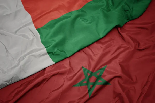 Waving colorful flag of morocco and national flag of madagascar. — Stock Photo, Image