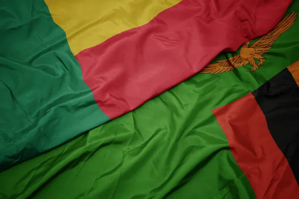 ザンビアのカラフルな旗とベナンの国旗を振って. — ストック写真