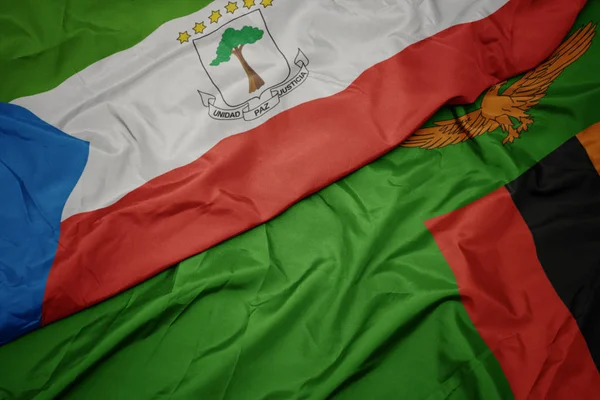 Ondeando colorida bandera de zambia y bandera nacional de Guinea Ecuatorial . —  Fotos de Stock
