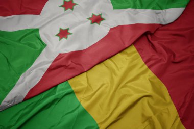 Mali 'nin renkli bayrağını sallıyor ve Burundi' nin ulusal bayrağını sallıyor .