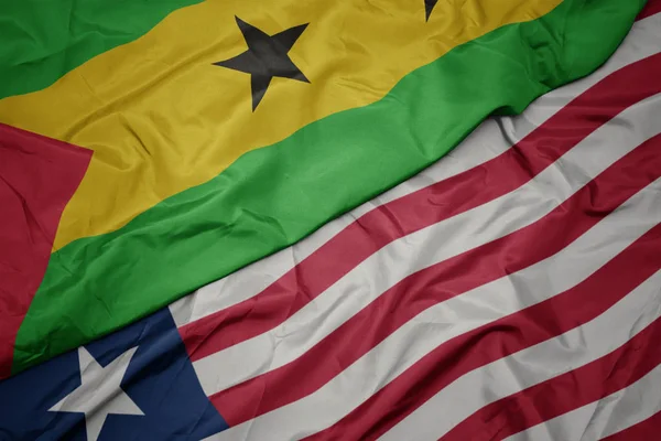 Sventolando bandiera colorata di liberia e bandiera nazionale di sao tomo e principe  . — Foto Stock