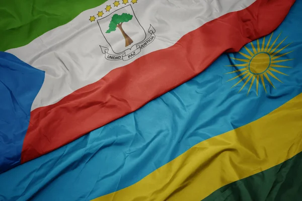 Ondeando colorida bandera de Ruanda y bandera nacional de Guinea Ecuatorial . —  Fotos de Stock