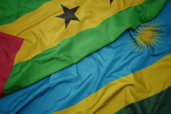 Ondeando colorida bandera de Ruanda y bandera nacional de sao tome y principe  . —  Fotos de Stock