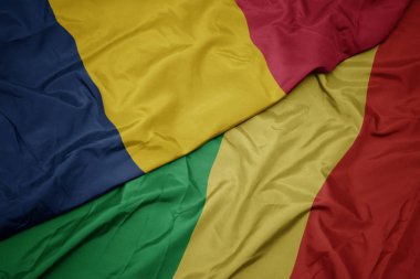 waving colorful flag of republic of the congo and national flag of chad.